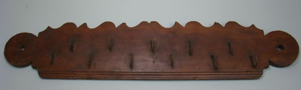 Appraisal: ANTIQUE GAME HANGING RACK In walnut with iron hooks Length