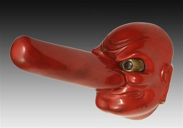 Appraisal: A JAPANESE RED LACQUERED 'NO' MASK with glaring eyes and