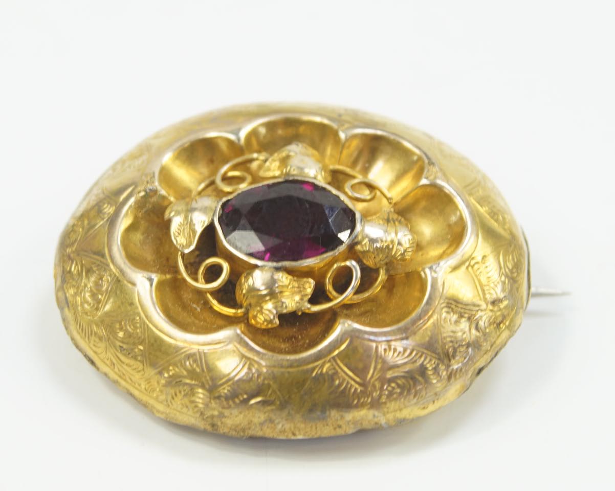 Appraisal: A Victorian memorial brooch set with a garnet hair filled