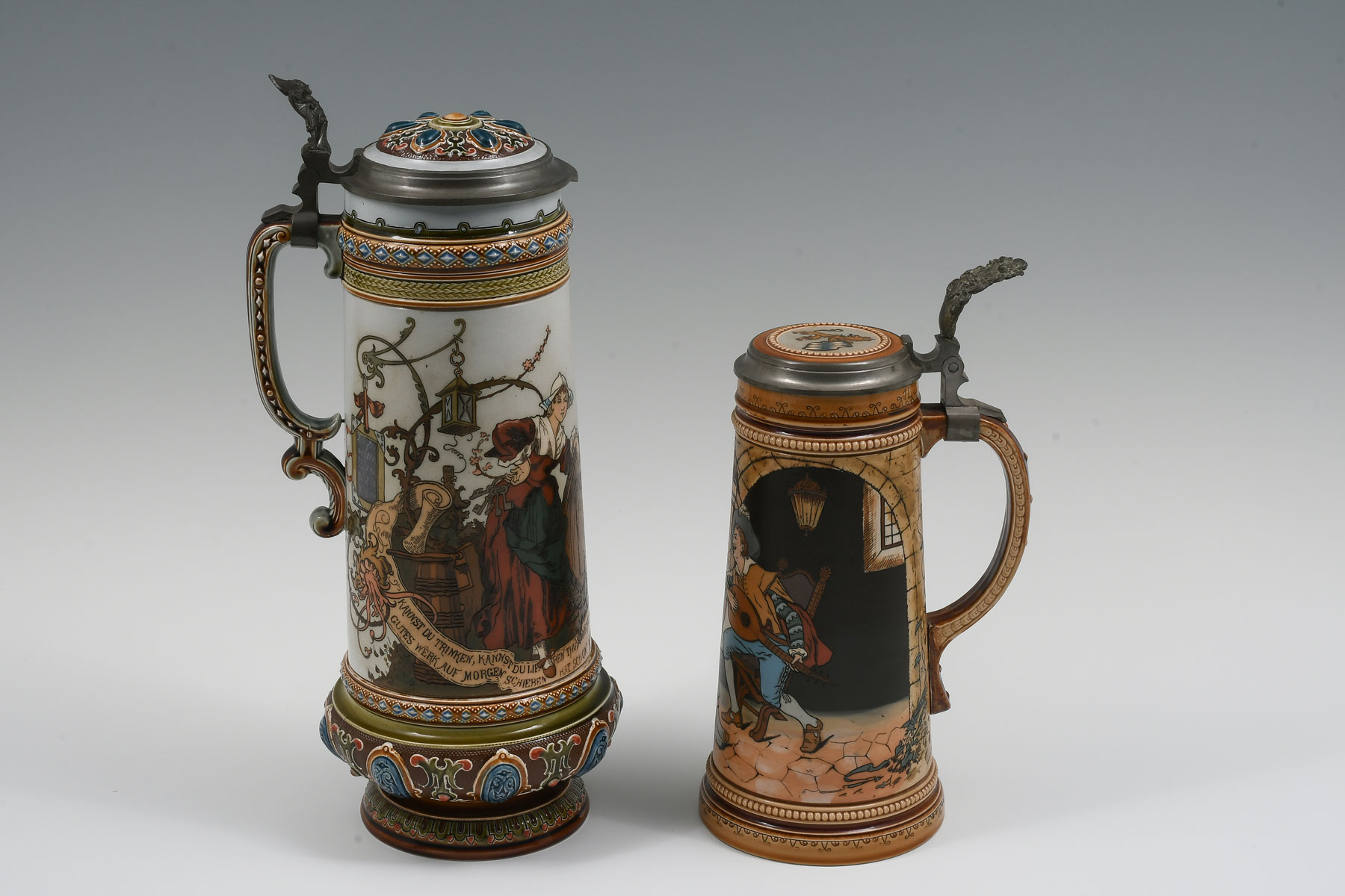 Appraisal: PC METTLACH FIGURAL STEINS Comprising - Mettlach Etched L with