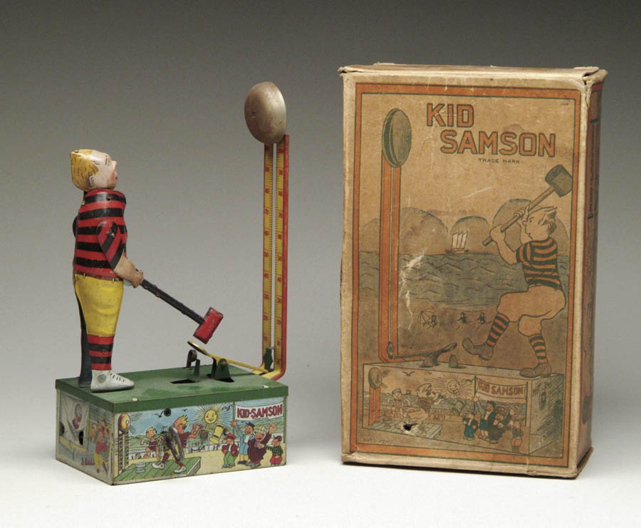 Appraisal: KID SAMSON TIN WINDUP W OB Kid Samson stands on