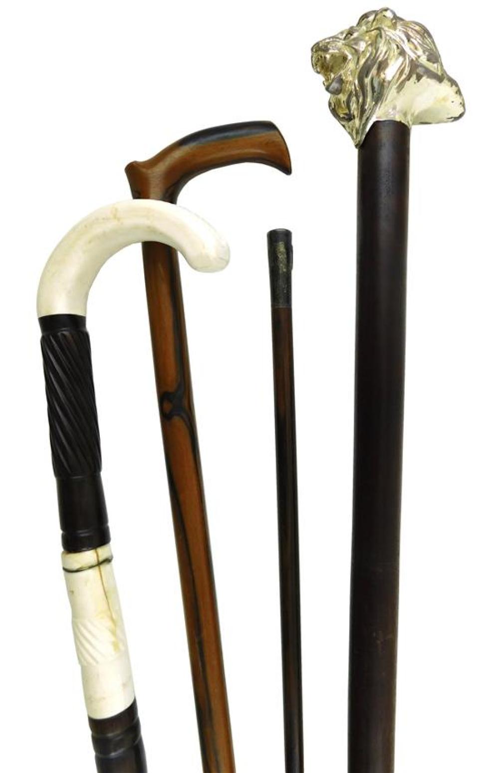 Appraisal: Four walking sticks and canes all wooden one Tiffany Co