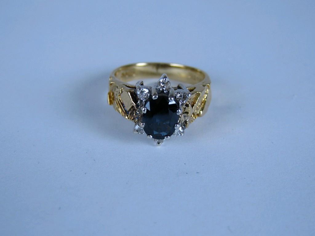 Appraisal: A 's Sapphire and Diamond Cluster Ring claw-set oval-cut sapphire