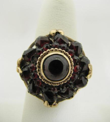 Appraisal: Lady's k yellow gold vintage garnet ring with round and