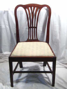 Appraisal: A pair of Georgian mahogany dining chairs in the Hepplewhite