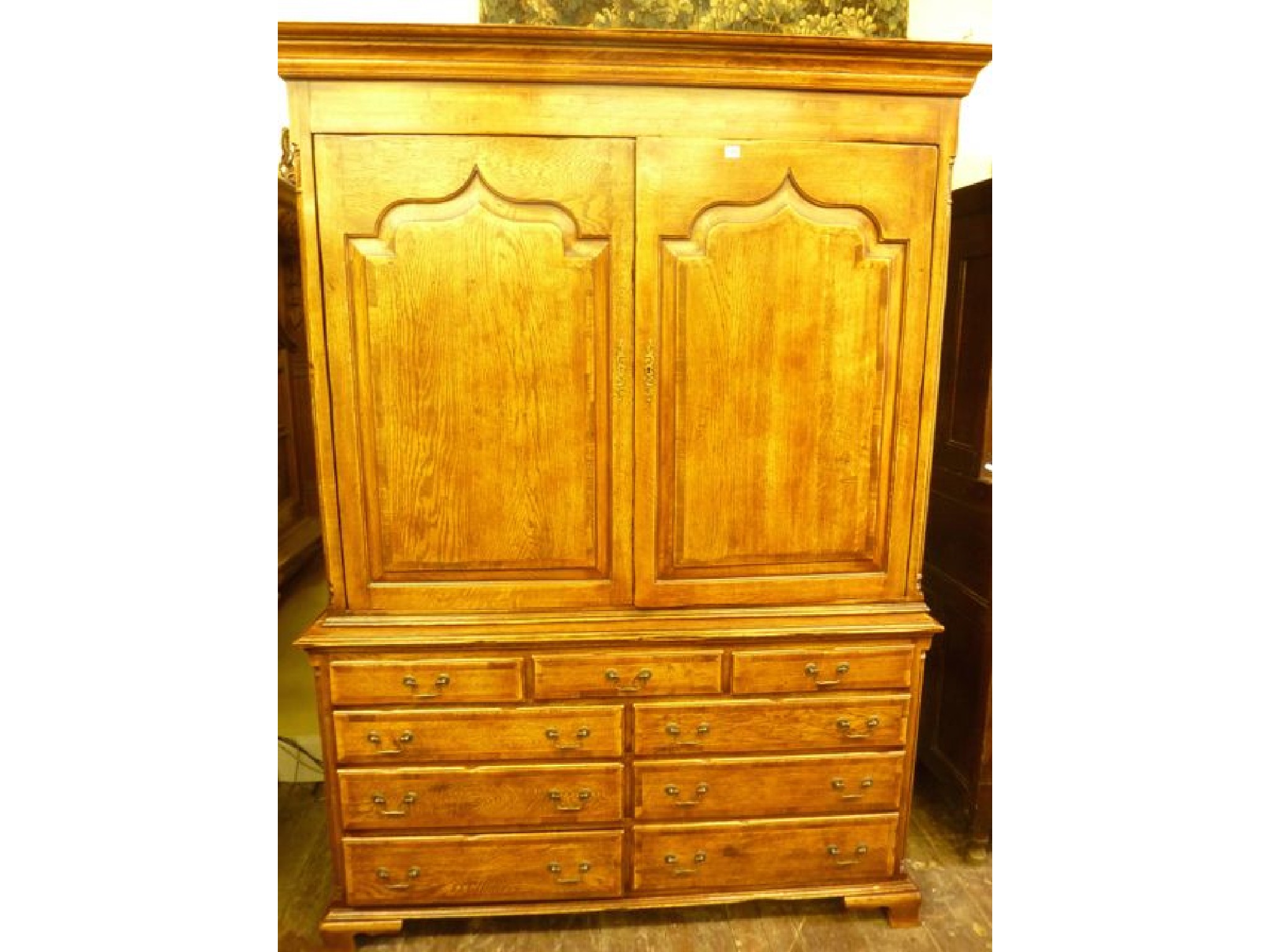 Appraisal: A good quality reproduction oak chest cupboard with distressed aged