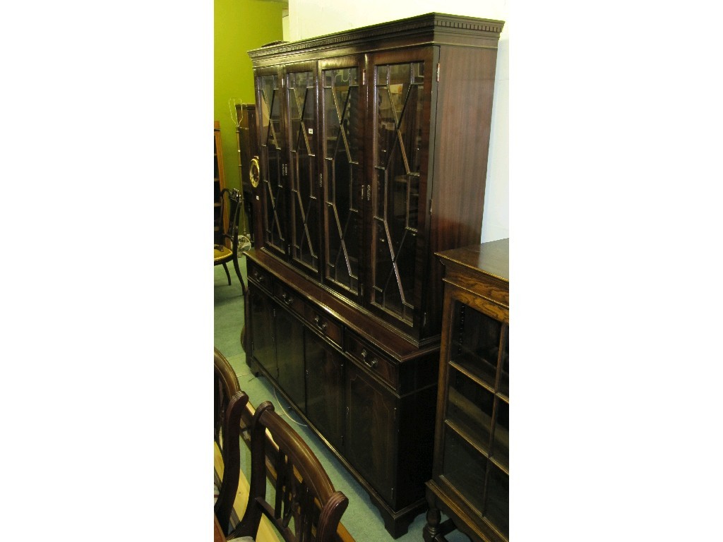 Appraisal: Reproduction mahogany four door bookcase on cabinet