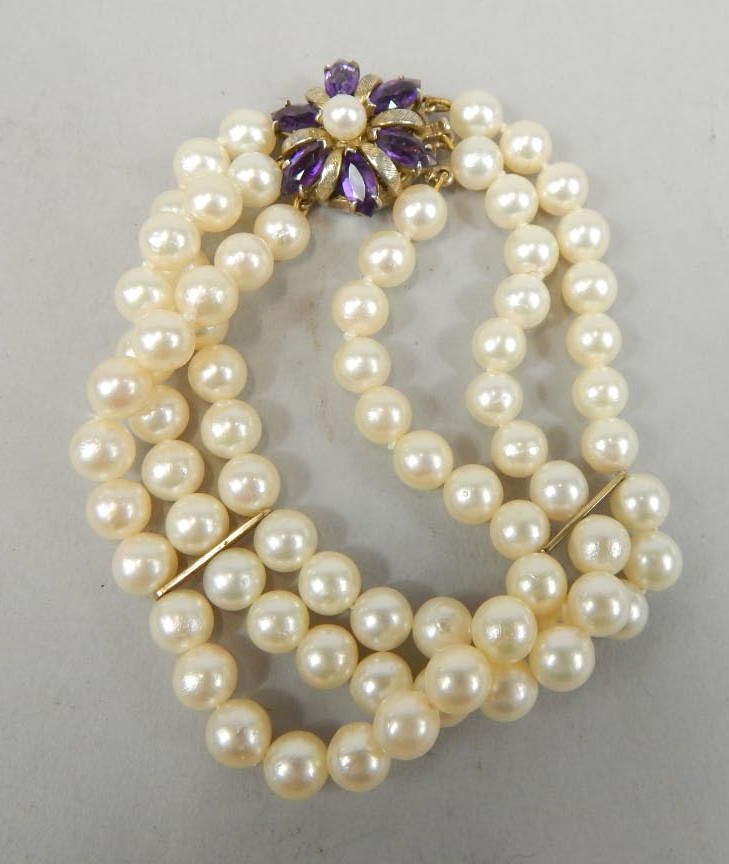 Appraisal: A three row cultured pearl bracelet with silver and amethyst