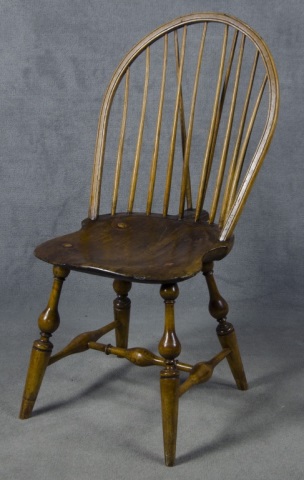 Appraisal: Braceback Windsor Side Chair th century Nine-spindle back Plank seat