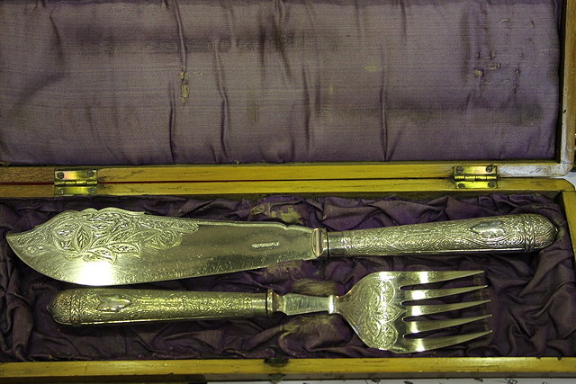 Appraisal: A PAIR OF VICTORIAN SILVER PLATED FISH SERVERS with engraved