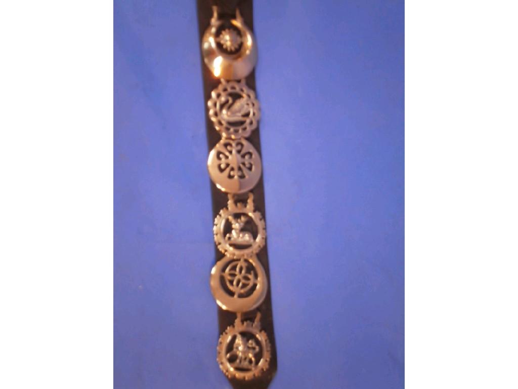 Appraisal: A six brass martingale with pierced crescents swan stag and