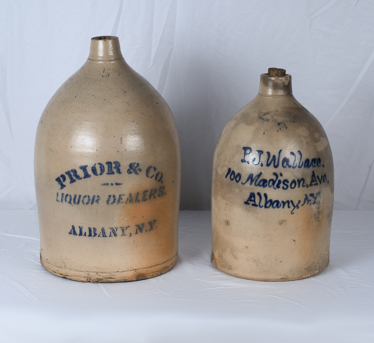 Appraisal: DECORATEDE AMERICAN STONEWARE JUGS Comprising - Three gallon jug decorated