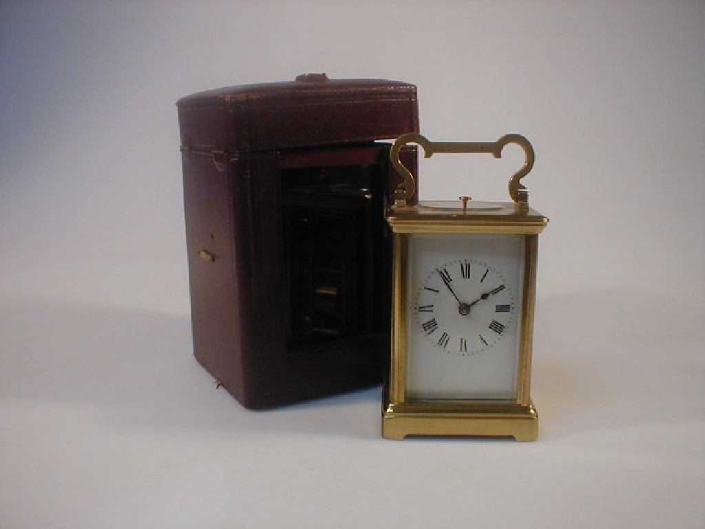 Appraisal: A gilt brass chiming carriage clock together with an associated