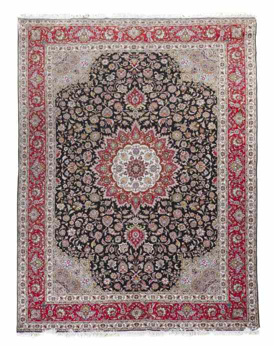 Appraisal: A Persian Wool Carpet having a foliate central medallion set