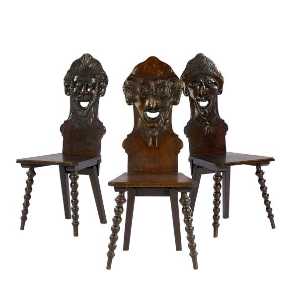 Appraisal: Set of three chairs with carved faces all smiling late