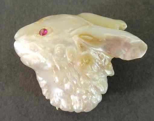 Appraisal: Carved mother of pearl rabbit head pin with a ruby