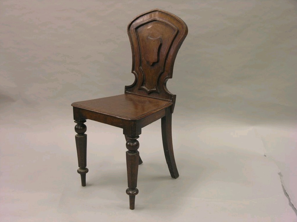 Appraisal: A Victorian mahogany hall chair the back with shield device