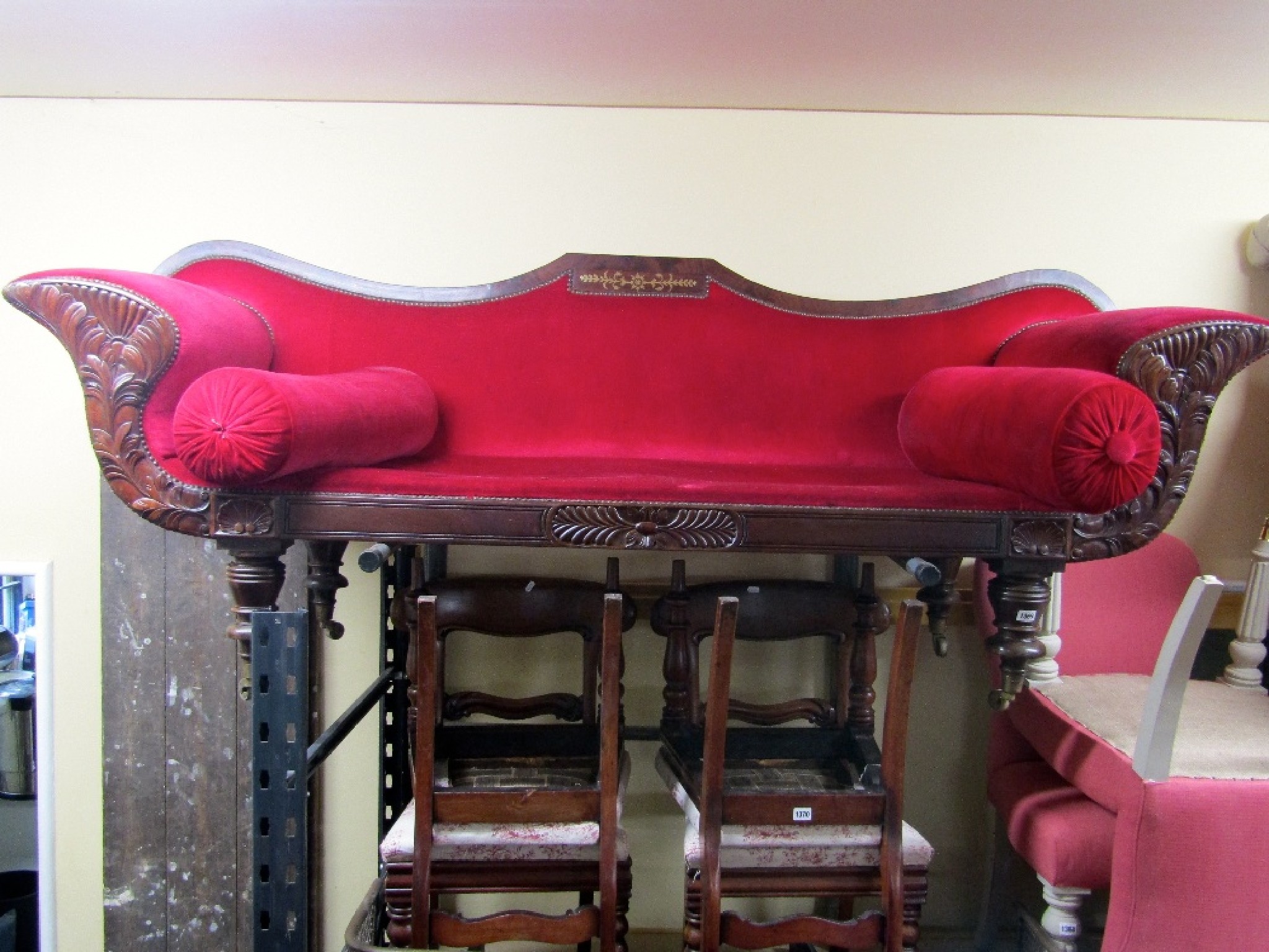 Appraisal: A Regency mahogany and brass inlaid sofa with swept supports