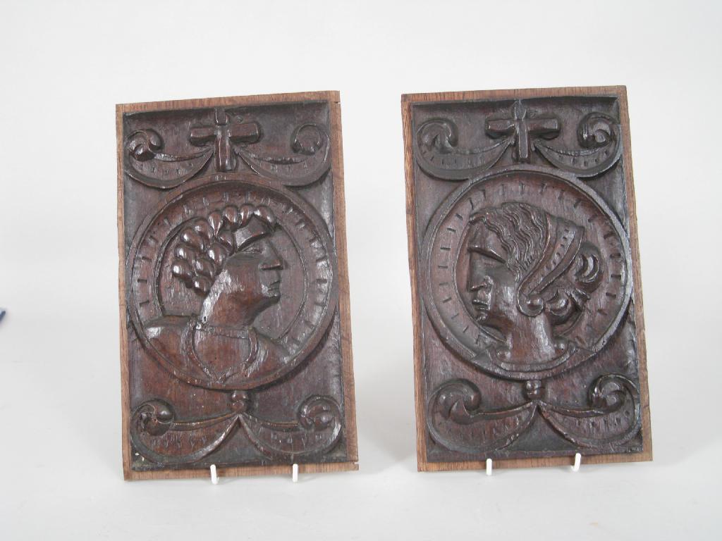 Appraisal: Pair of antique oak Panels carved heads within roundels scroll