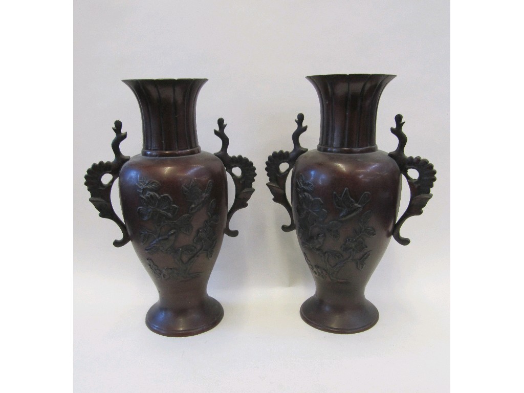 Appraisal: Pair of oriental vases each decorated in relief with birds