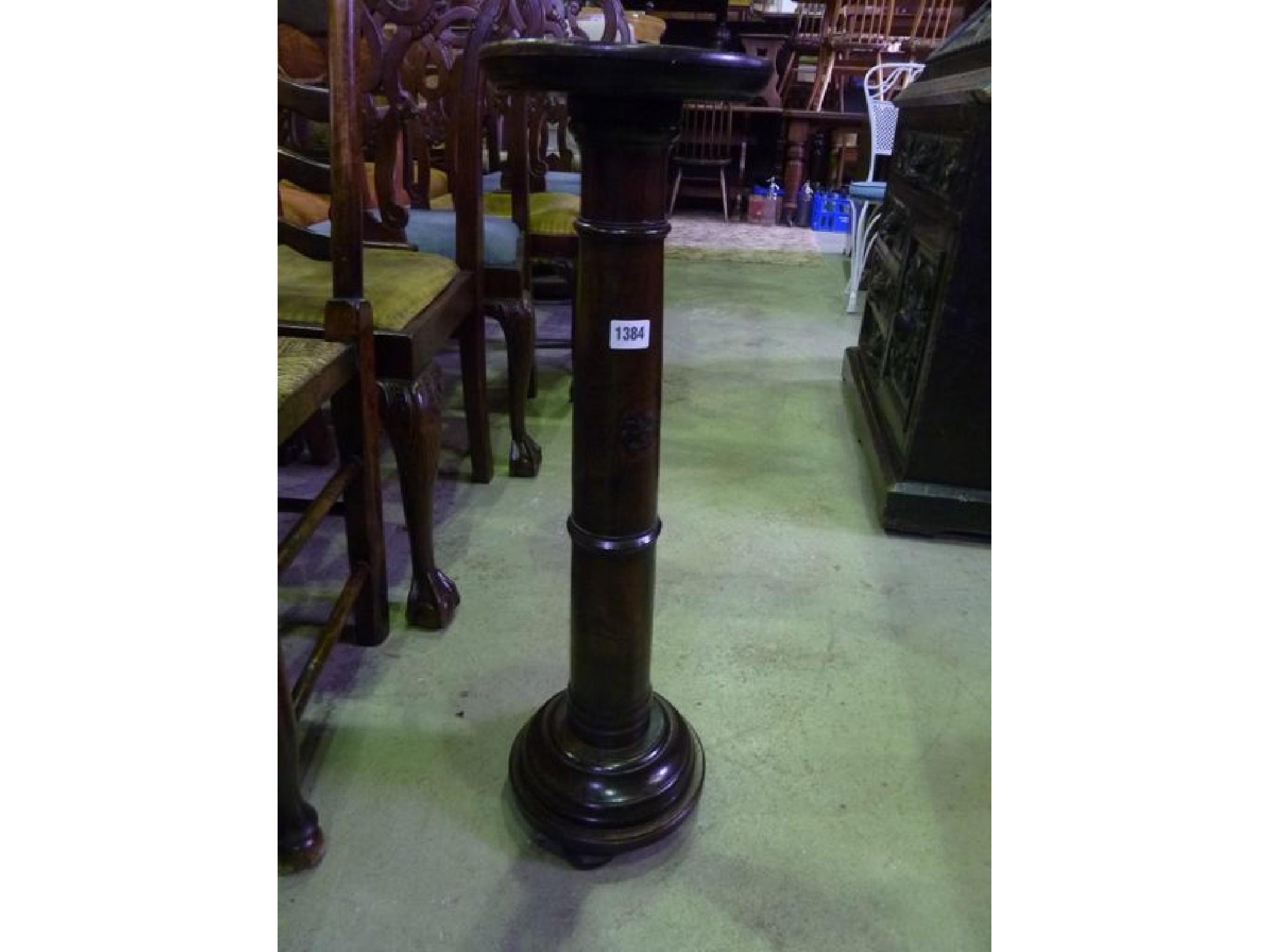 Appraisal: An oak jardinere stand with turned column and stepped disk