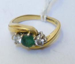 Appraisal: AN EMERALD AND DIAMOND THREE STONE RING the central faceted