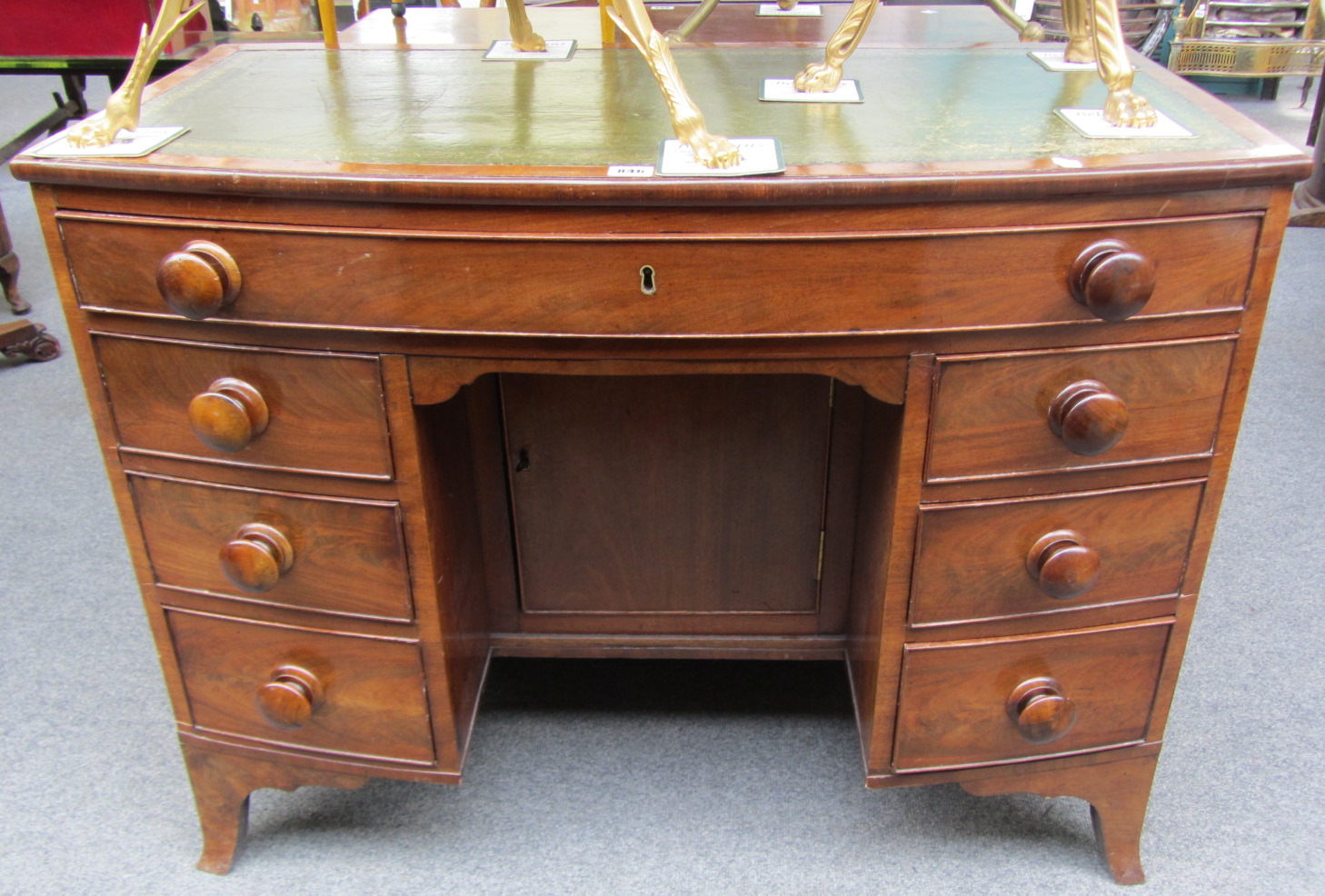 Appraisal: A th century mahogany bowfront kneehole writing desk with seven