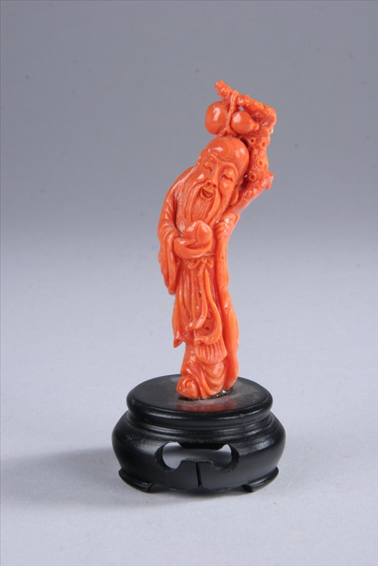 Appraisal: CHINESE CORAL FIGURE OF IMMORTAL Standing wearing long beard holding