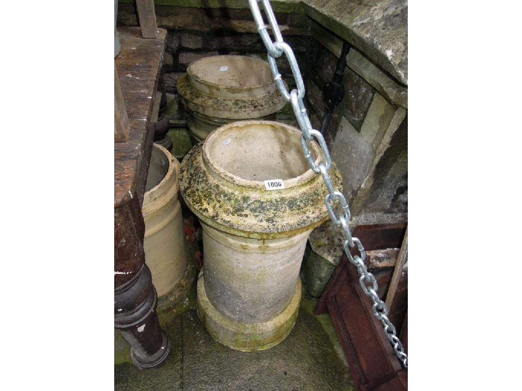 Appraisal: Three similar weathered buff coloured terracotta chimney pots of cylindrical