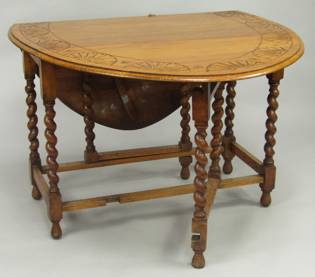 Appraisal: An oak gateleg dining table thC the top carved with