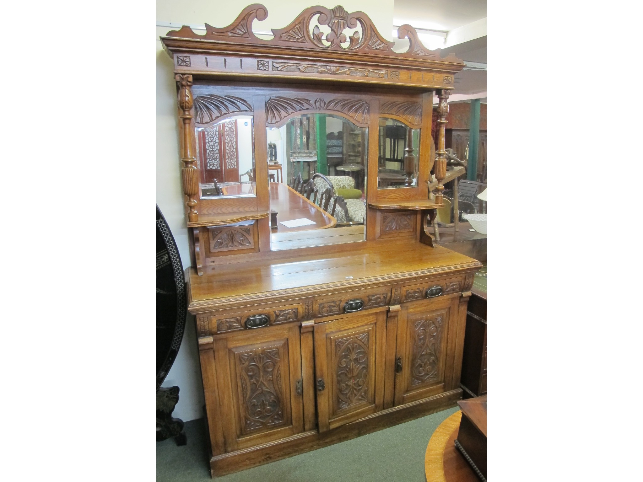 Appraisal: A Victorian oak mirrored back sideboard