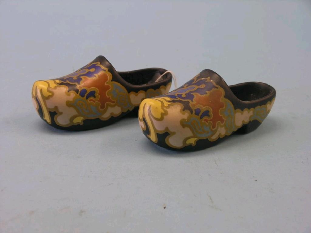 Appraisal: A pair of Gouda Holland ceramic clogs painted and gilded