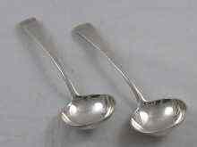 Appraisal: A pair of Georgian silver sauce ladles by Thomas Wallis