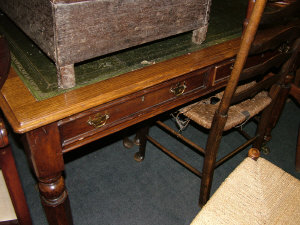 Appraisal: A Victorian oak writing table the leather inset top above