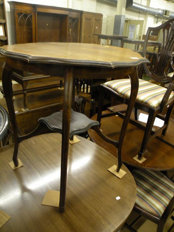 Appraisal: An Edwardian stained beech occasional table the top with a