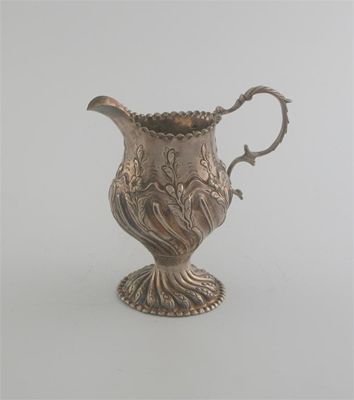 Appraisal: A George III embossed cream jug decorated with swirl fluting