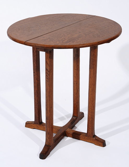 Appraisal: A COTSWOLD SCHOOL OAK CIRCULAR OCCASIONAL TABLE on four octagonal