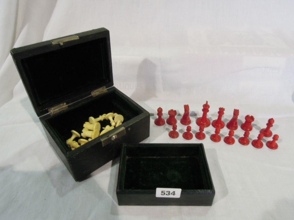 Appraisal: A complete ivory chess set with white and red stained