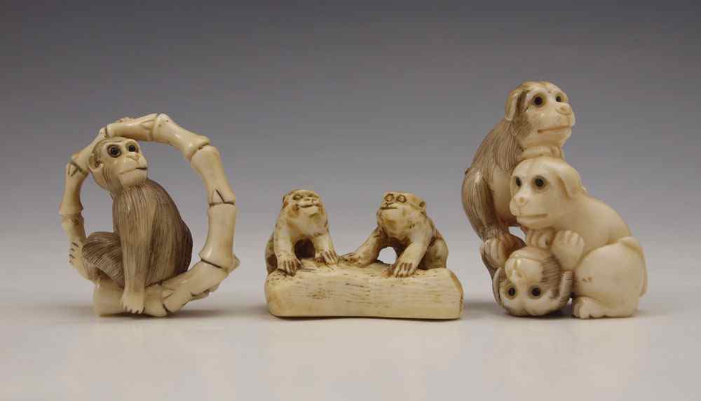 Appraisal: PIECE CARVED IVORY MONKEY DOGS NETSUKE To include dogs stacked