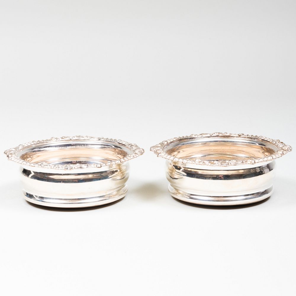 Appraisal: Pair of English Silver Plate Bottle Coasters Engraved with crests