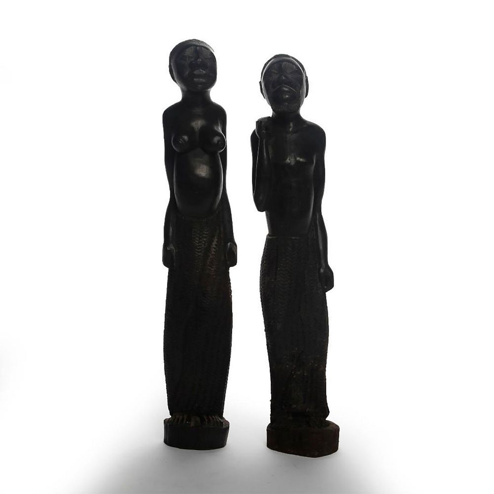 Appraisal: PAIR OF AFRICAN CARVED WOOD FIGURAL STATUES Shirtless male and