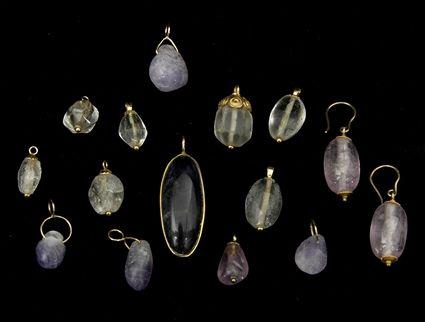 Appraisal: Six Gold and Amethyst Pendants Seven Gold and Rock Crystal