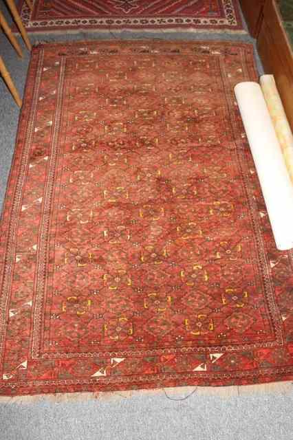 Appraisal: A BOKHARA RED GROUND RUG with foliate designs within a