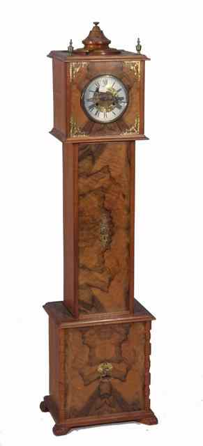 Appraisal: A STYLISED GRANDMOTHER CLOCK with applied walnut veneered panels and