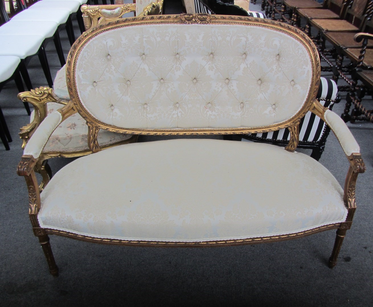 Appraisal: A Louis XVI style gilt framed open arm sofa on