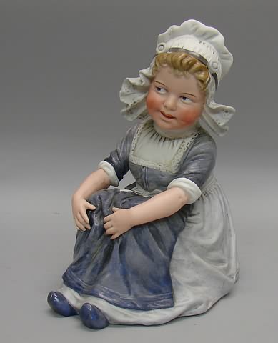 Appraisal: Unmarked bisque figurine of sitting Dutch girl with hands on