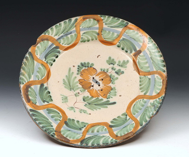 Appraisal: A CONTINENTAL TIN GLAZED DISH with flower decoration diameter AF