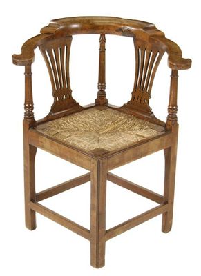 Appraisal: A George III fruitwood and oak corner armchair with pierced