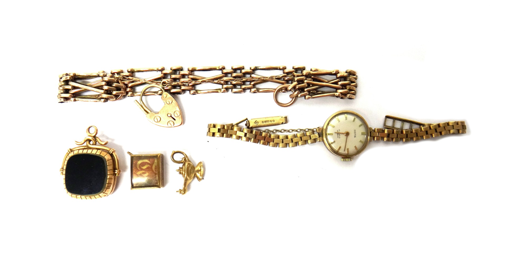 Appraisal: A gold bar and oval link gate bracelet with a