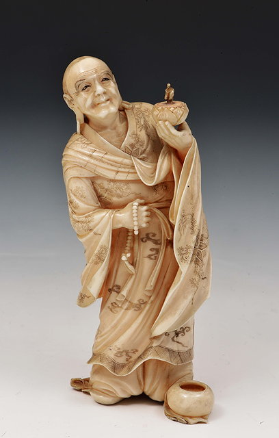 Appraisal: A Japanese ivory okimono of a standing rakanMeiji periodsigned Ryogetsu